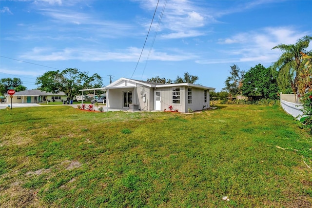 view of yard featuring cooling unit and a carport