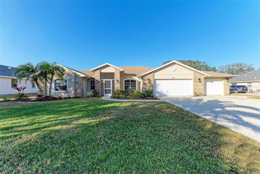 single story home with a front yard and a garage