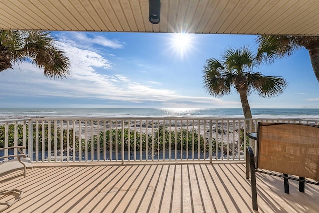 deck featuring a water view and a view of the beach