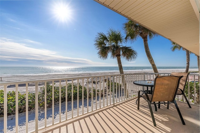 balcony with a view of the beach and a water view