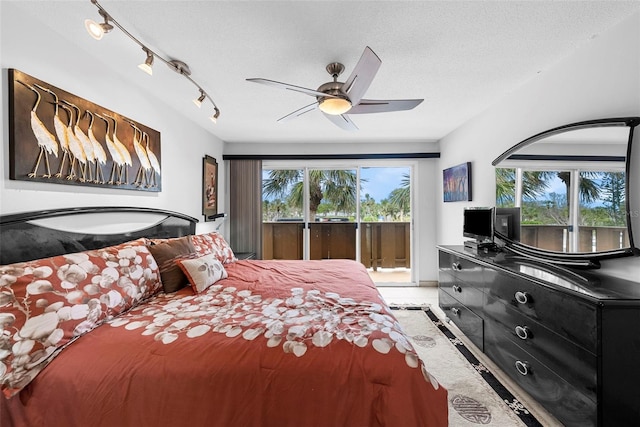 tiled bedroom with ceiling fan, access to exterior, and a textured ceiling