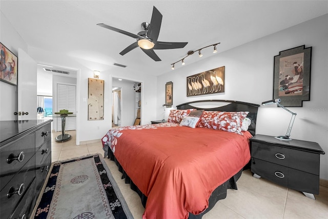 tiled bedroom with ceiling fan