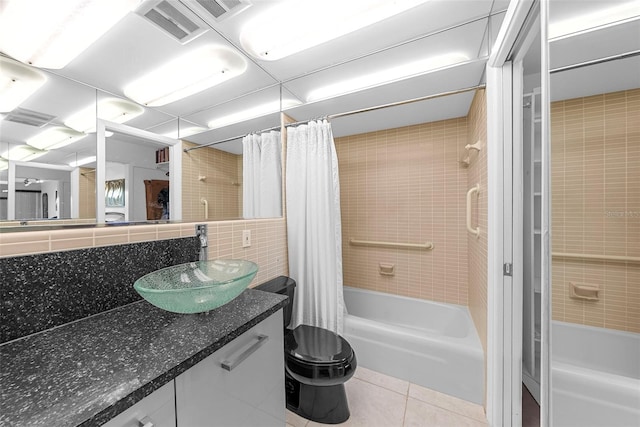 full bathroom featuring toilet, backsplash, shower / bath combo with shower curtain, tile patterned floors, and vanity