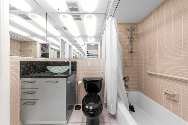 full bathroom featuring tile patterned floors, vanity, tile walls, toilet, and shower / tub combo with curtain