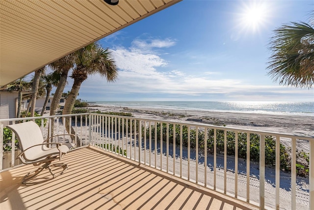 balcony with a view of the beach and a water view