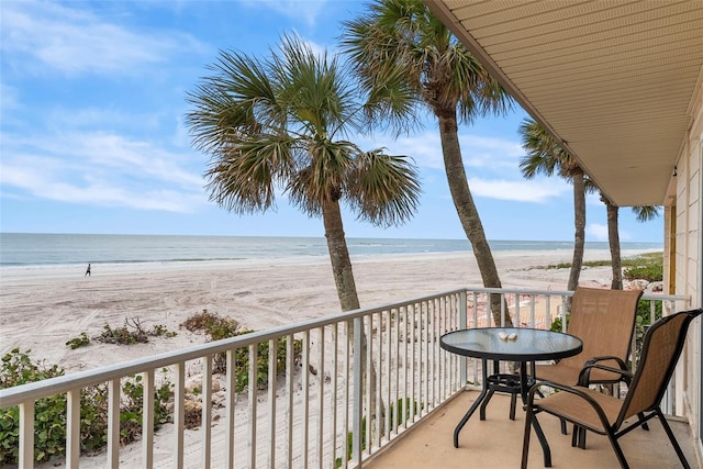 balcony with a water view and a beach view