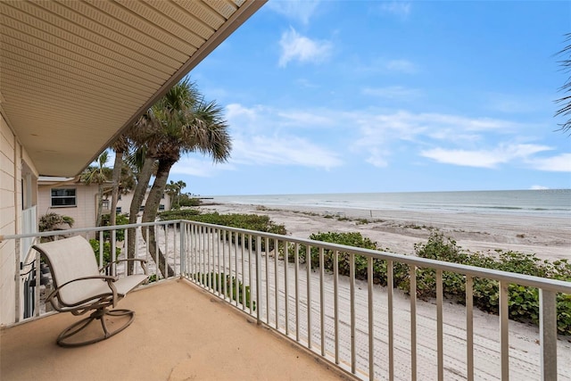 balcony with a water view and a beach view