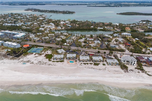 birds eye view of property with a water view and a view of the beach