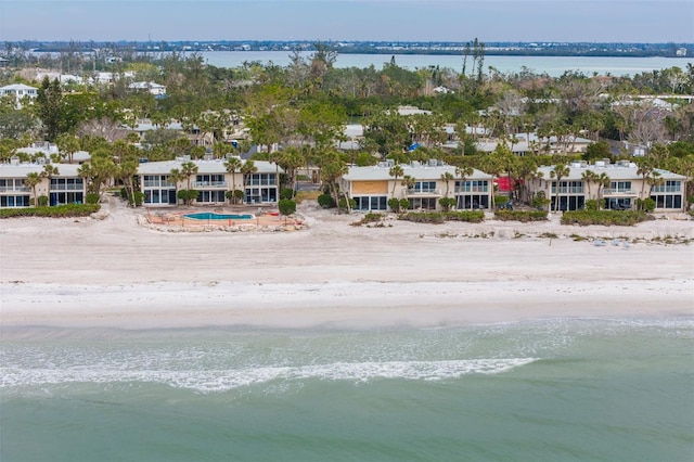 drone / aerial view featuring a beach view and a water view