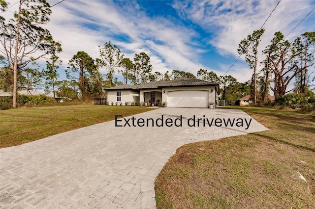 view of front of home featuring a garage and a front yard