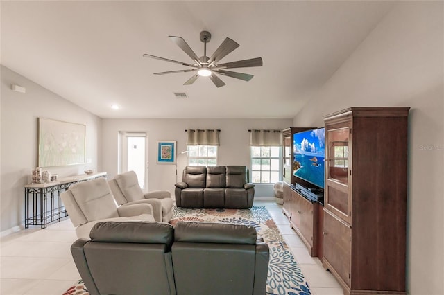 living room with ceiling fan, light tile patterned floors, and lofted ceiling