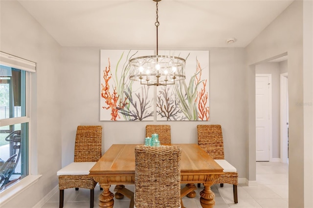 dining space featuring light tile patterned floors and a notable chandelier