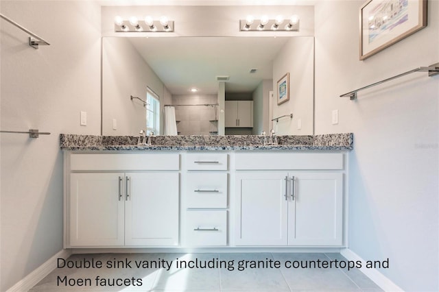 bathroom featuring tile patterned flooring, walk in shower, and vanity