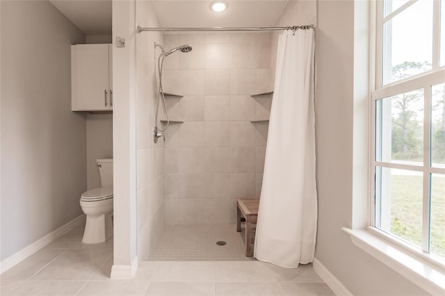 bathroom with toilet, tile patterned floors, and a shower with shower curtain