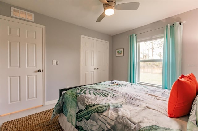 bedroom featuring ceiling fan, a closet, and tile patterned flooring