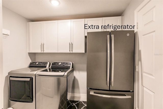 laundry area featuring washer and dryer and cabinets