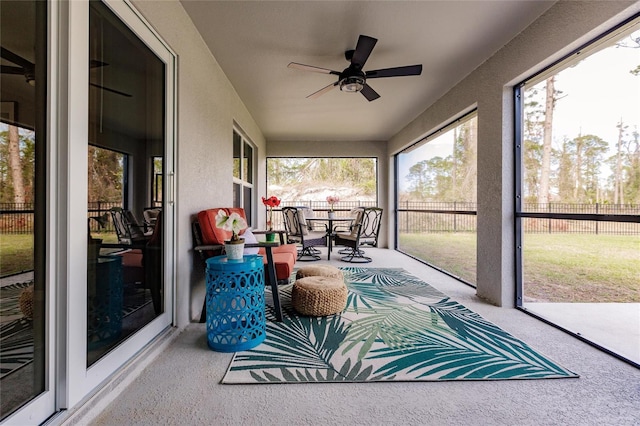 sunroom / solarium featuring ceiling fan