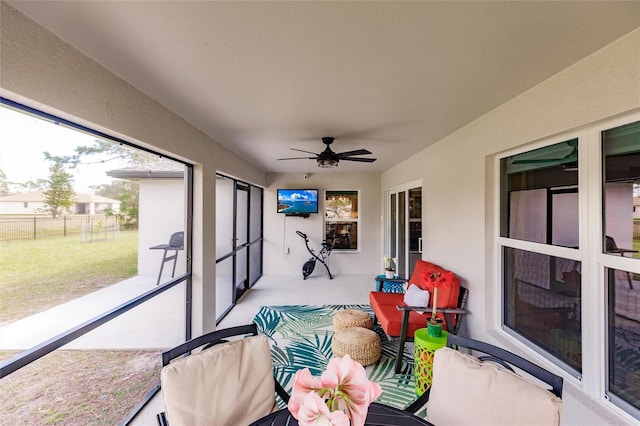 sunroom with ceiling fan and plenty of natural light