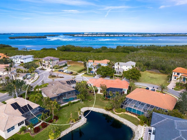 birds eye view of property with a water view