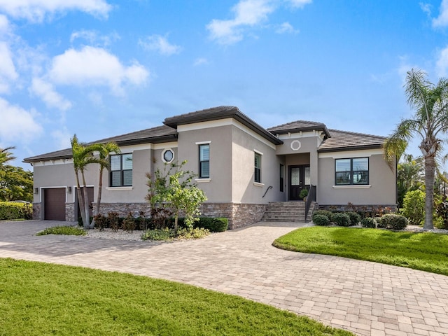 view of front of property with a garage and a front lawn