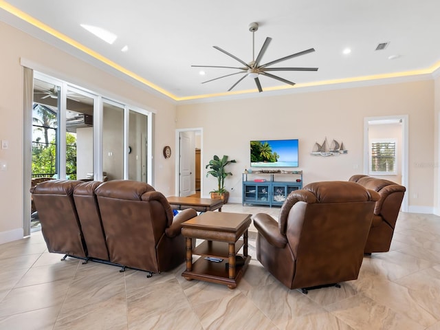 living room with ceiling fan and crown molding