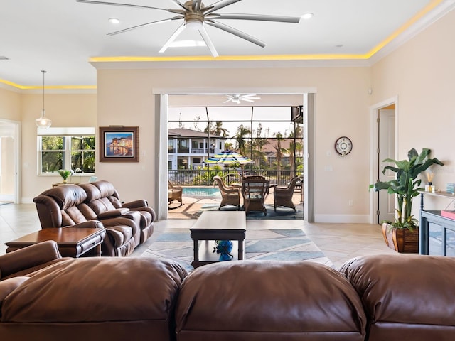 living room with crown molding, light tile patterned flooring, and ceiling fan