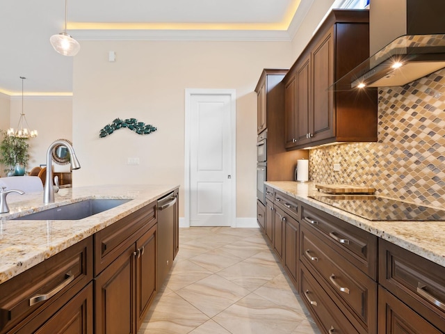 kitchen with sink, backsplash, pendant lighting, and light stone counters