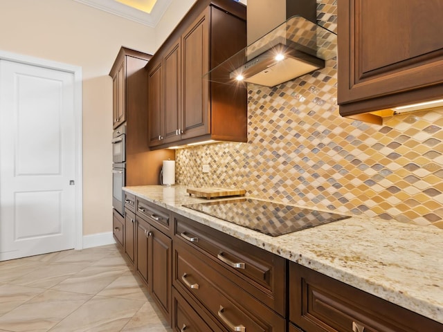 kitchen featuring wall chimney range hood, backsplash, light stone counters, black electric cooktop, and crown molding