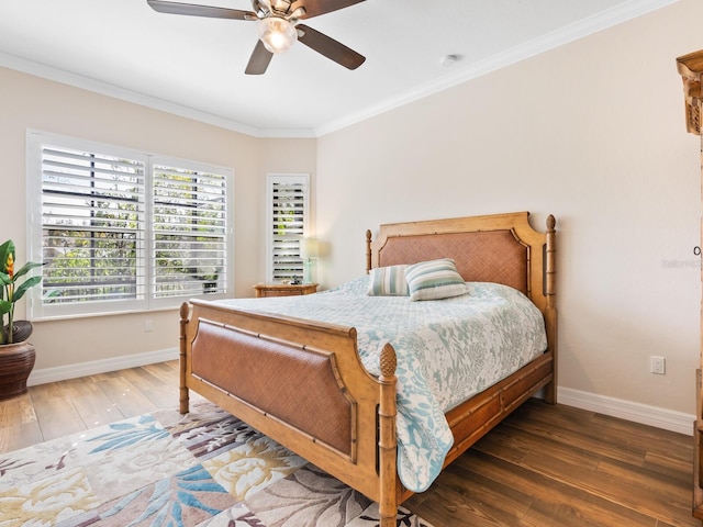 bedroom featuring ceiling fan, ornamental molding, and dark hardwood / wood-style flooring