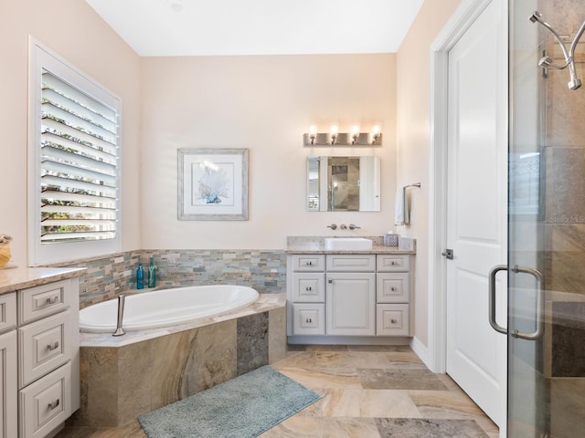 bathroom featuring vanity and separate shower and tub