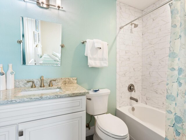 full bathroom with vanity, toilet, and shower / bath combination with curtain