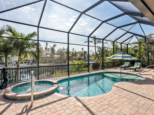 view of swimming pool featuring glass enclosure, a patio area, an in ground hot tub, a water view, and pool water feature