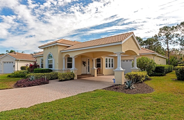 mediterranean / spanish-style house with a front yard and a garage