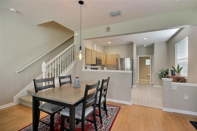 dining room with light hardwood / wood-style flooring