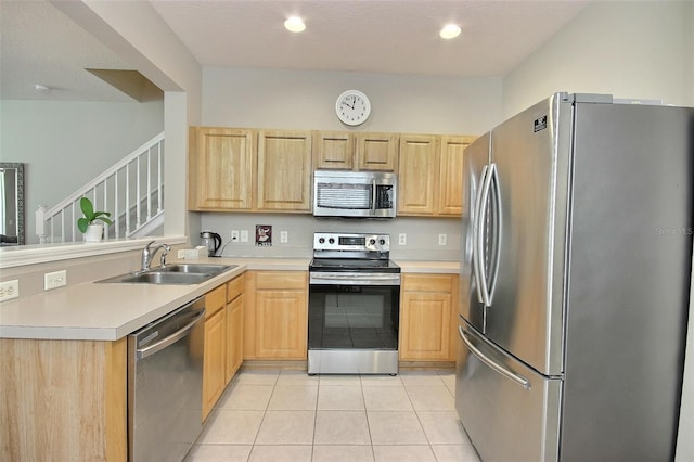 kitchen with sink, light brown cabinetry, appliances with stainless steel finishes, and light tile patterned flooring