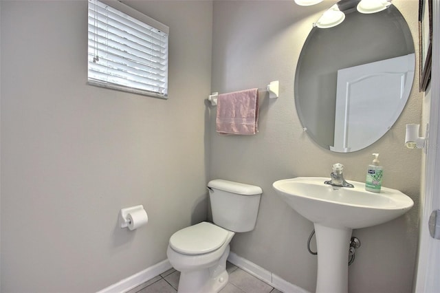 bathroom with sink, toilet, and tile patterned flooring