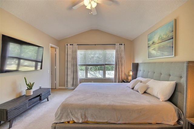 bedroom with ceiling fan, light carpet, and vaulted ceiling