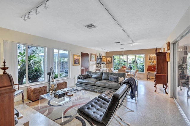 living room with track lighting and a textured ceiling