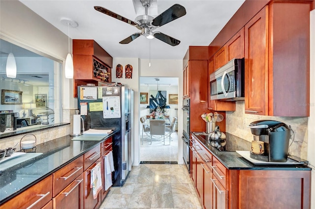 kitchen featuring decorative light fixtures, ceiling fan, dark stone counters, decorative backsplash, and black appliances