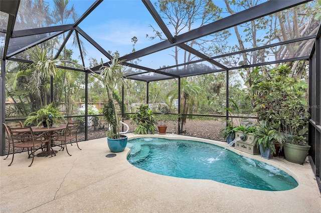 view of swimming pool featuring pool water feature, a patio area, and a lanai