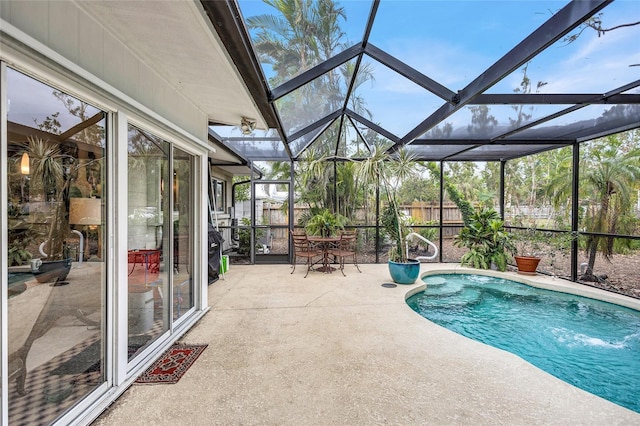 view of swimming pool featuring pool water feature, a patio, and glass enclosure