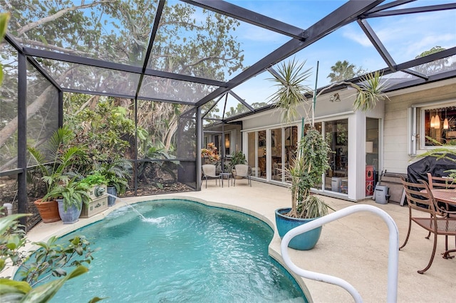 view of swimming pool featuring pool water feature, a patio area, and glass enclosure