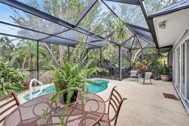 exterior space with a swimming pool with hot tub and glass enclosure