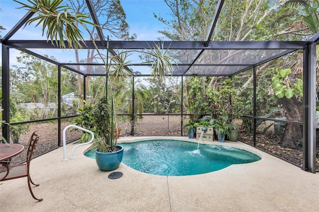 view of pool featuring pool water feature, glass enclosure, and a patio area