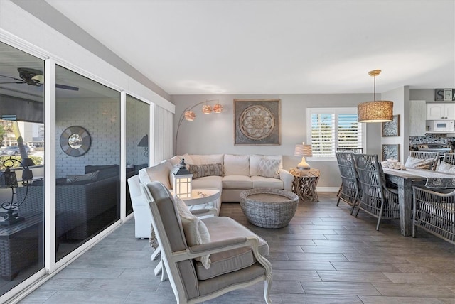 living area featuring a ceiling fan and wood finished floors