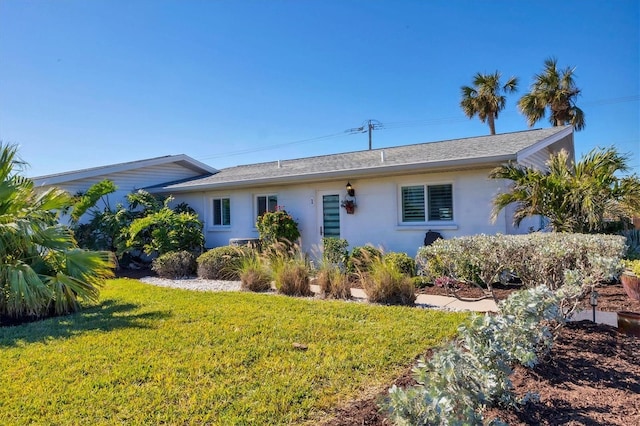 view of front of house with a front lawn and stucco siding