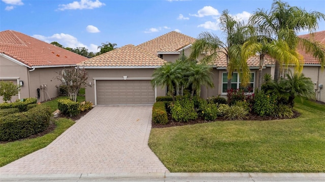 mediterranean / spanish house with a front yard and a garage