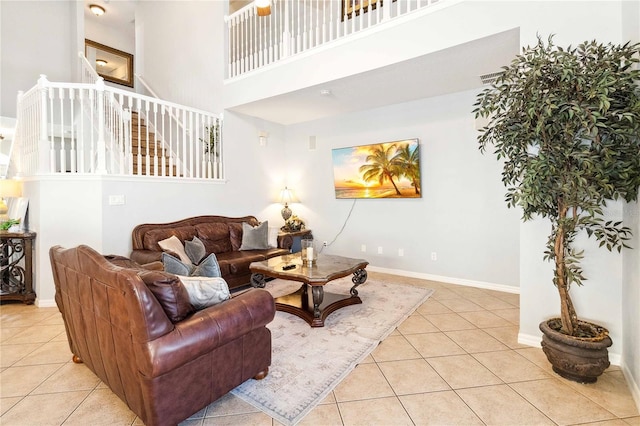 tiled living room with a towering ceiling