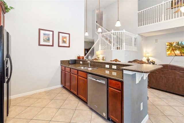 kitchen with black refrigerator with ice dispenser, stainless steel dishwasher, decorative light fixtures, and light tile patterned floors