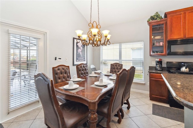 dining area featuring lofted ceiling, a chandelier, light tile patterned floors, and a healthy amount of sunlight